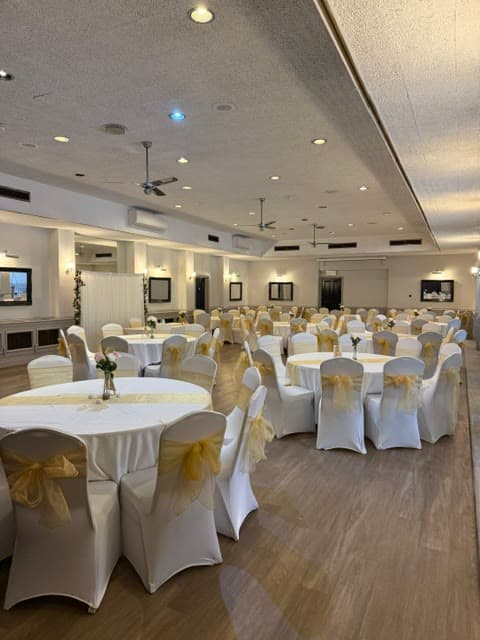 The Banqueting Suite dressed with round tables and gold detailing
